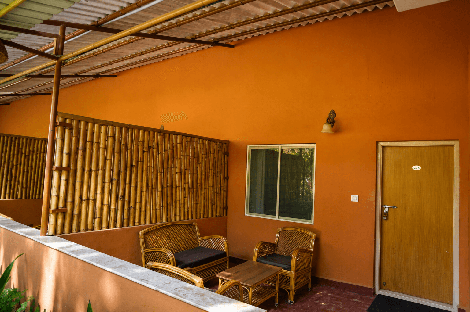 Room patio with bamboo screen and rattan seating